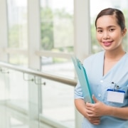 Smiling health professional in a hallway