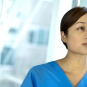 Nurse in scrubs looking forward