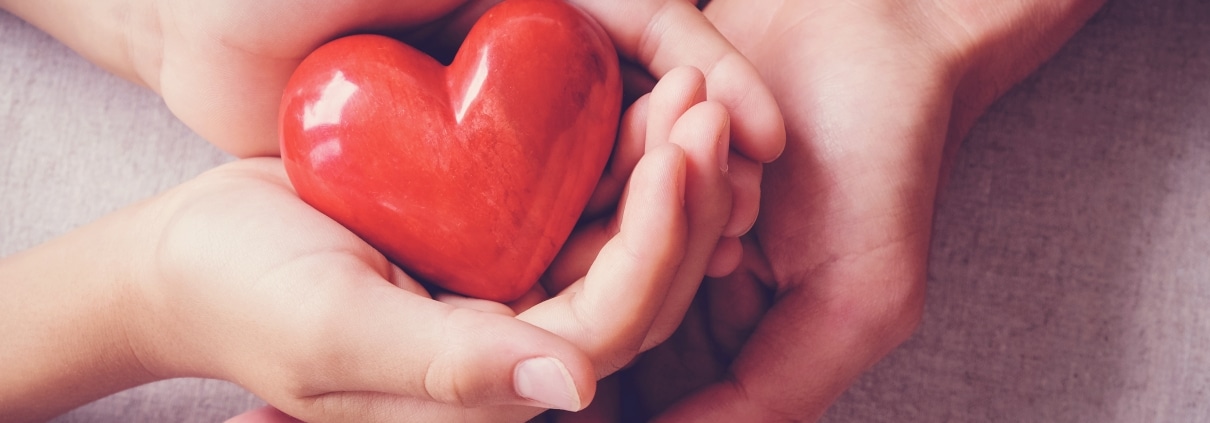 Hands holding a red heart