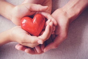 Hands holding a red heart