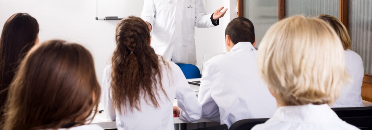 Multinational interns and professor having a discussion