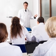 Multinational interns and professor having a discussion