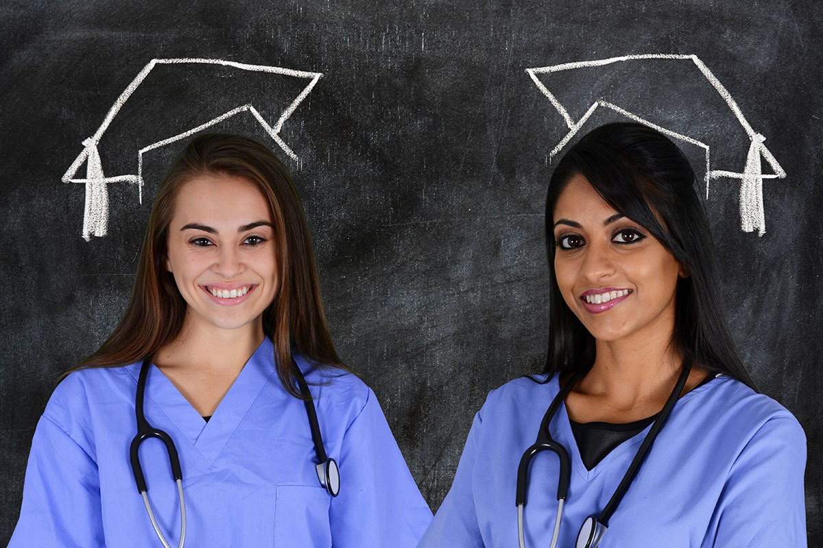 Smiling female graduates