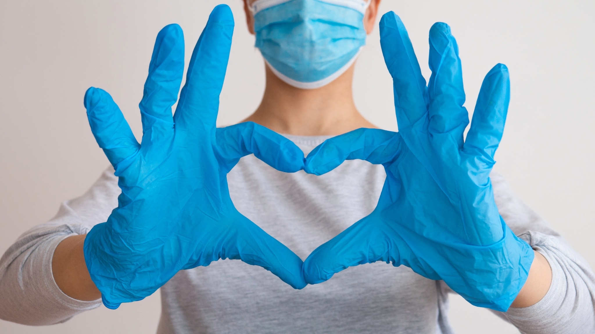 Healthcare worker making a heart with their hands