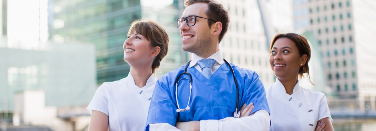 A team of nurses standing outside