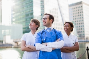 A team of nurses standing outside