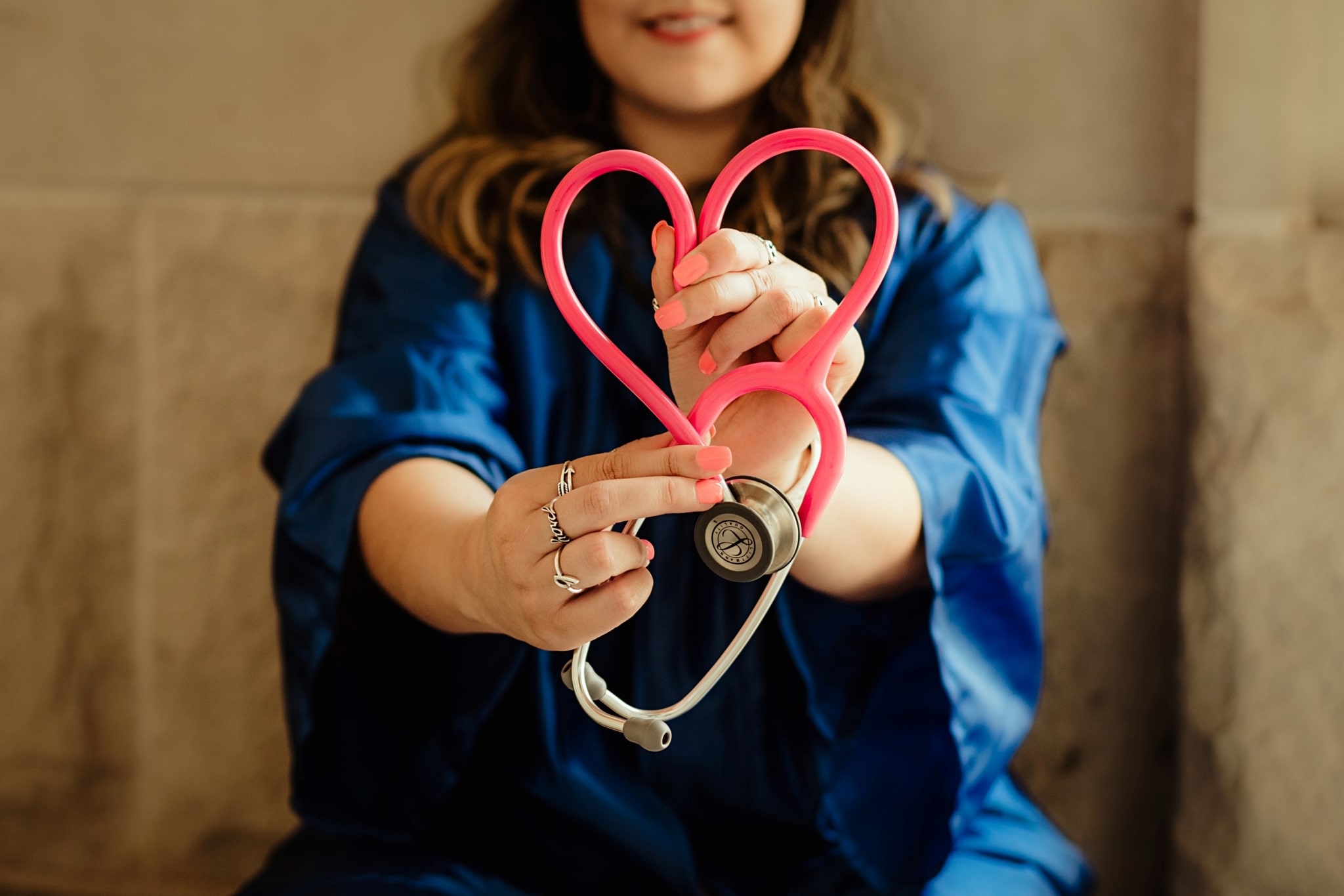 Graduate holding a stethoscope