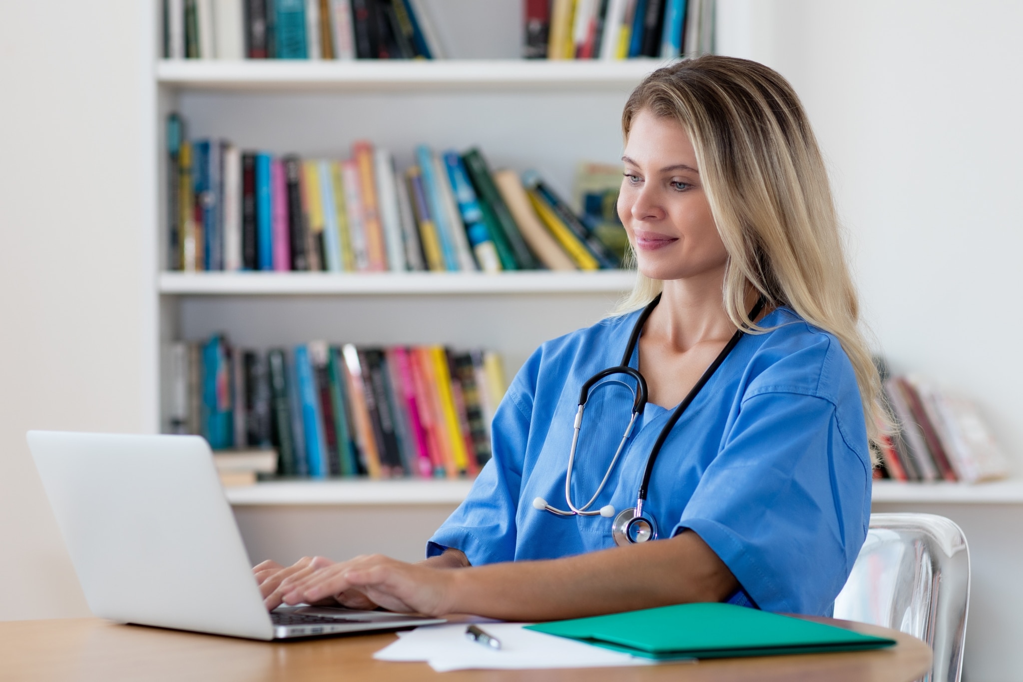 Beautiful nurse typing on a laptop
