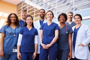 Smiling medical team standing outside