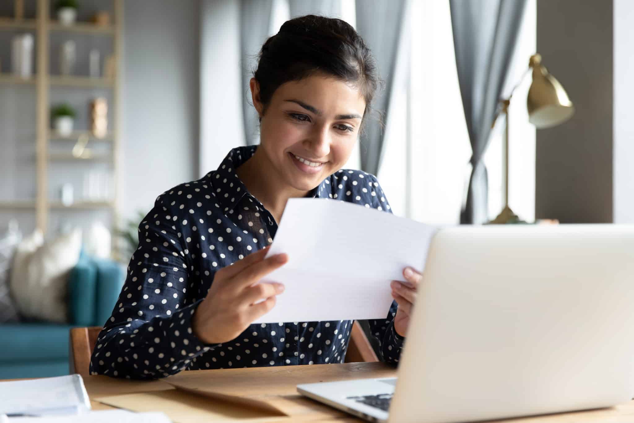 Smiling young woman at her laptop