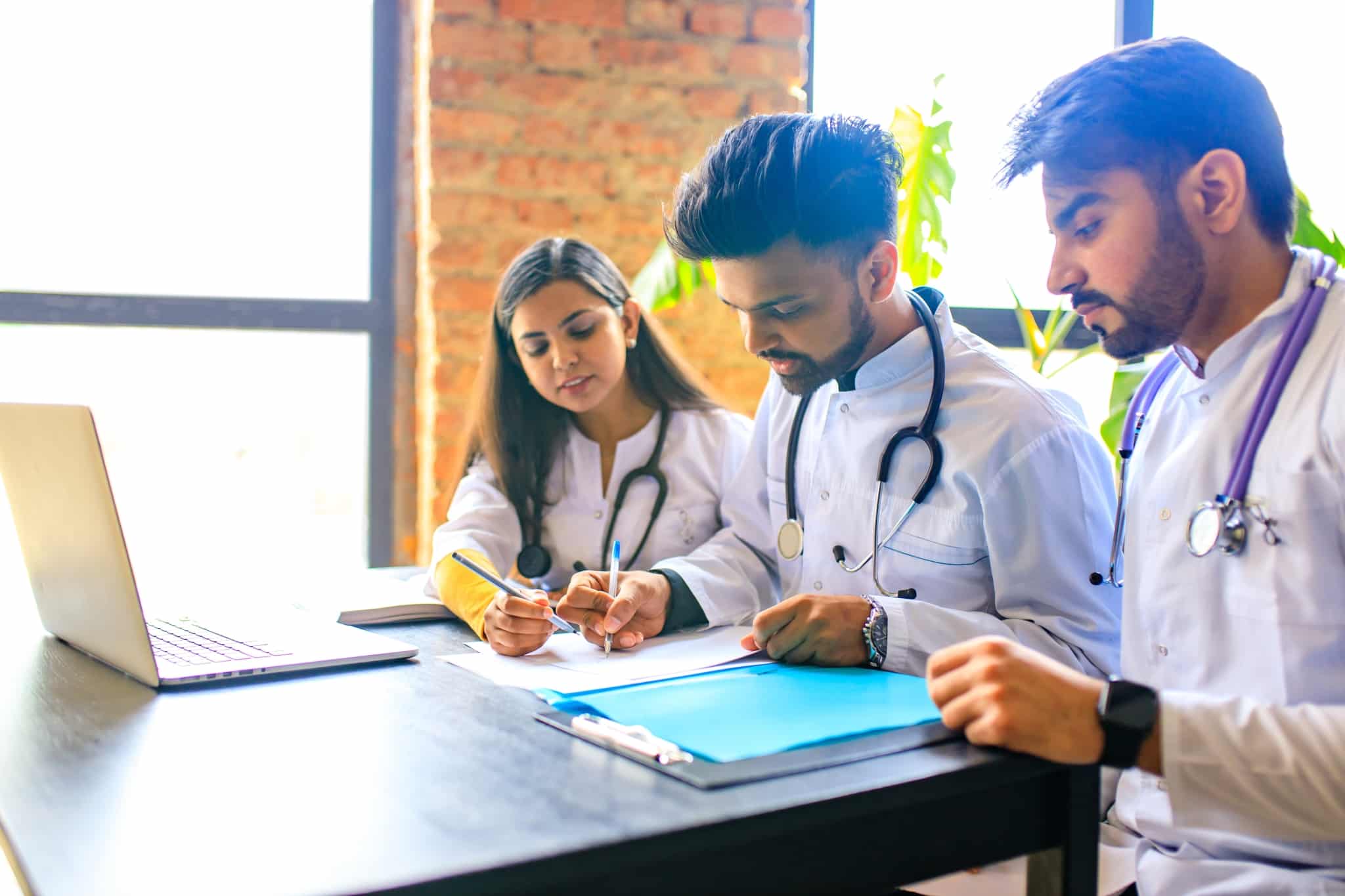 Medical students taking notes at a table