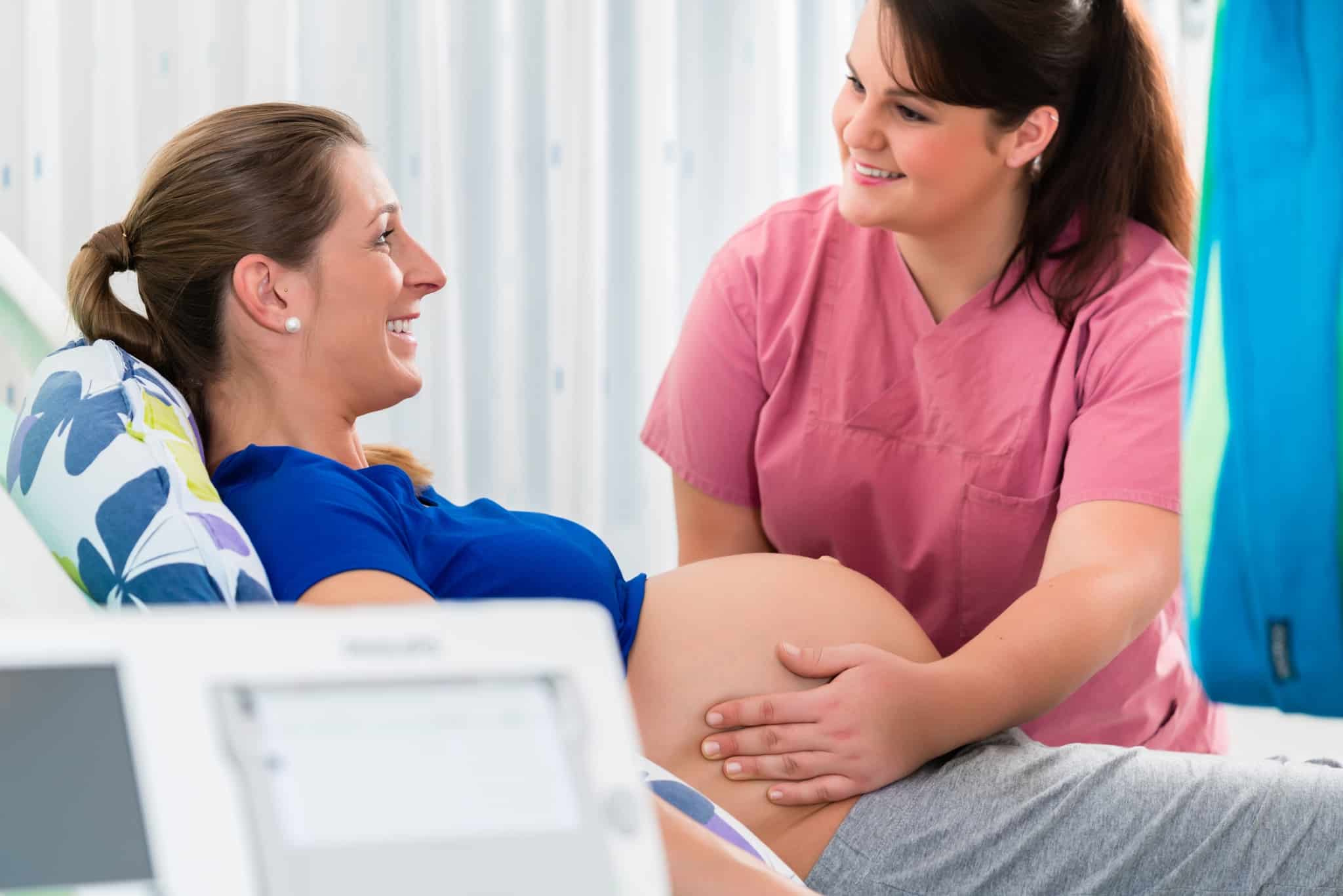 Midwife examining a patient in labor