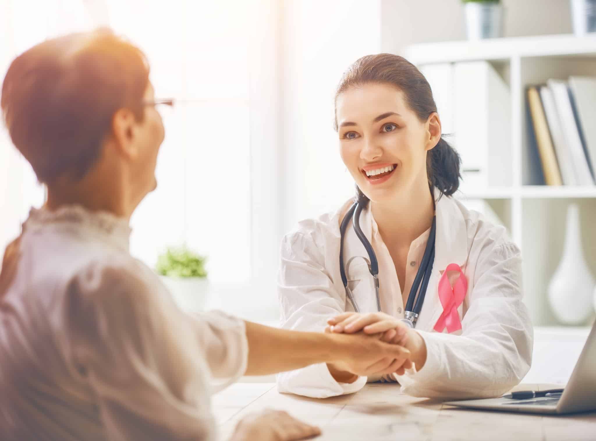 Medical professional wearing a pink ribbon