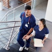 Two medical professionals on a staircase