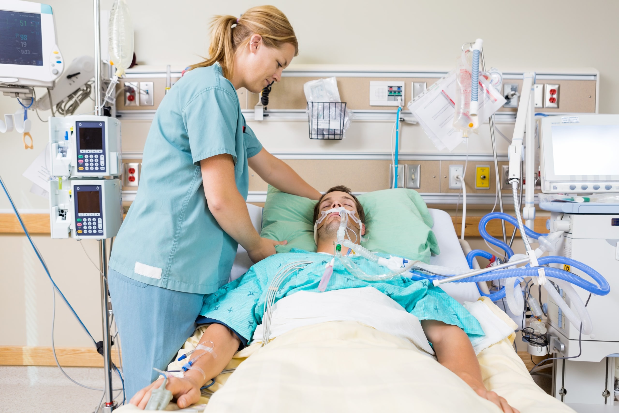 Female nurse checking on a male patient