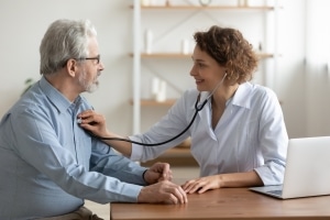 Nurse taking a man's heartrate