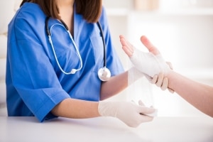 Close up of a nurse wrapping a wound