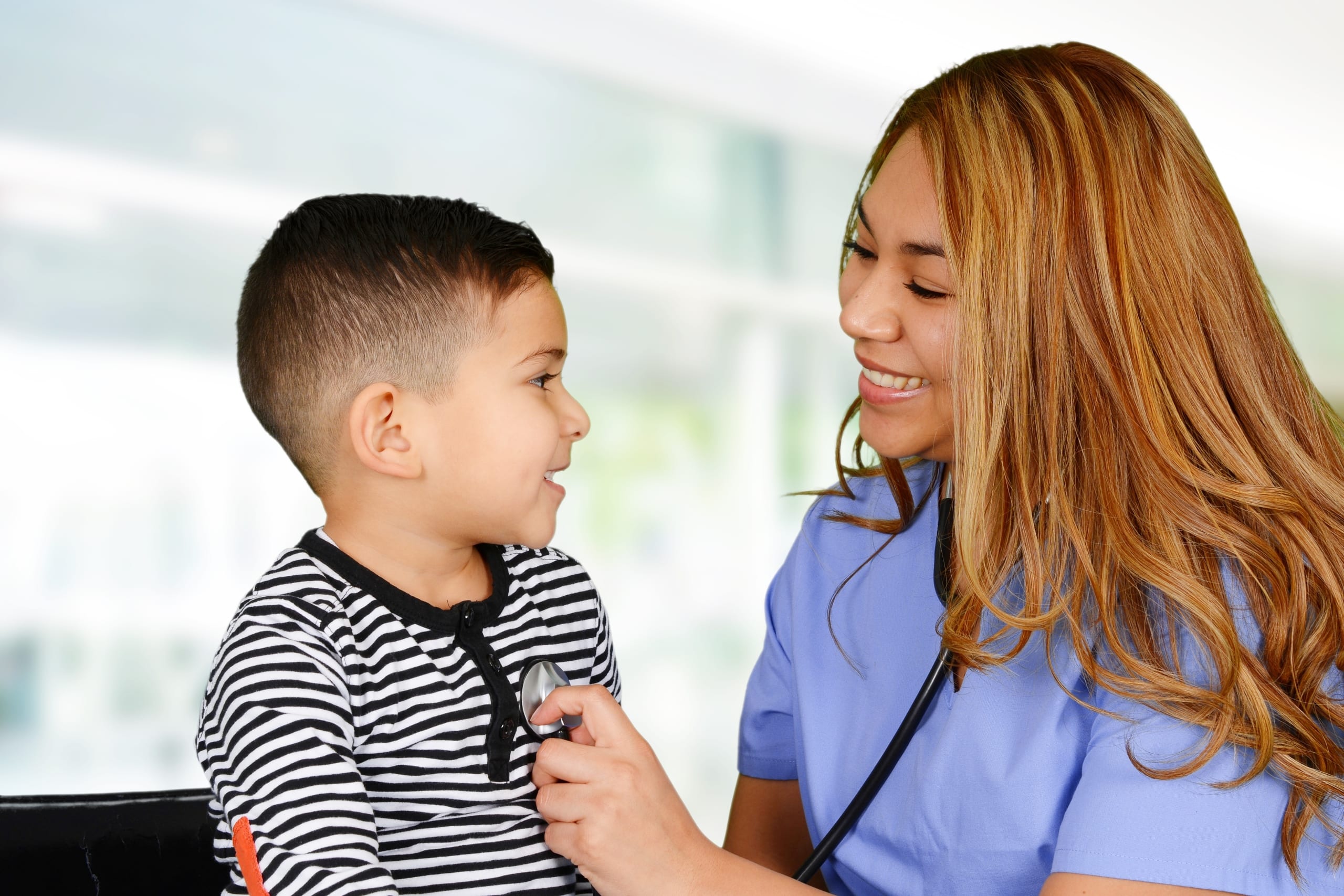 Female nurse examining a child