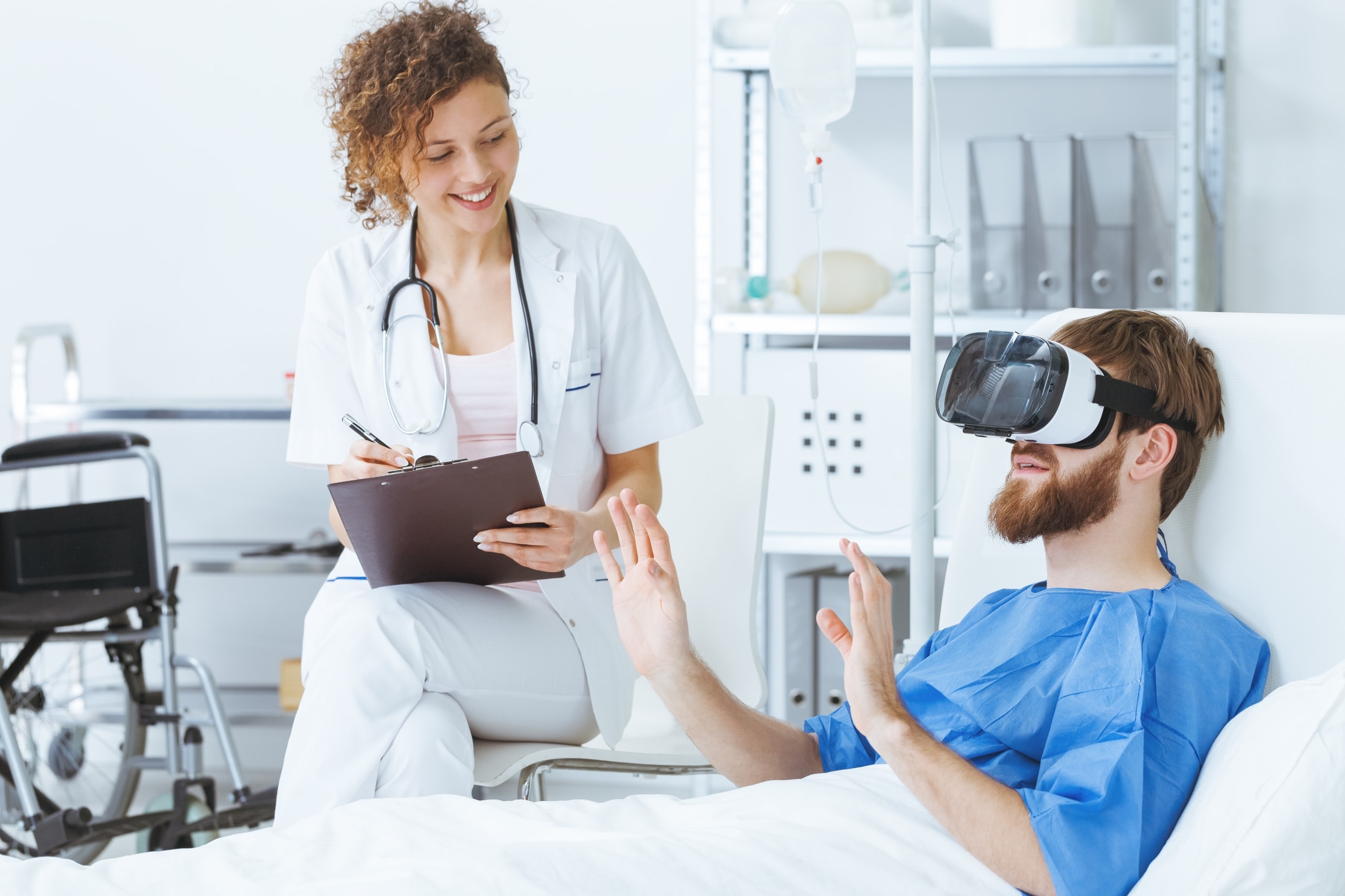 Psychiatric nurse with a patient using virtual reality goggles