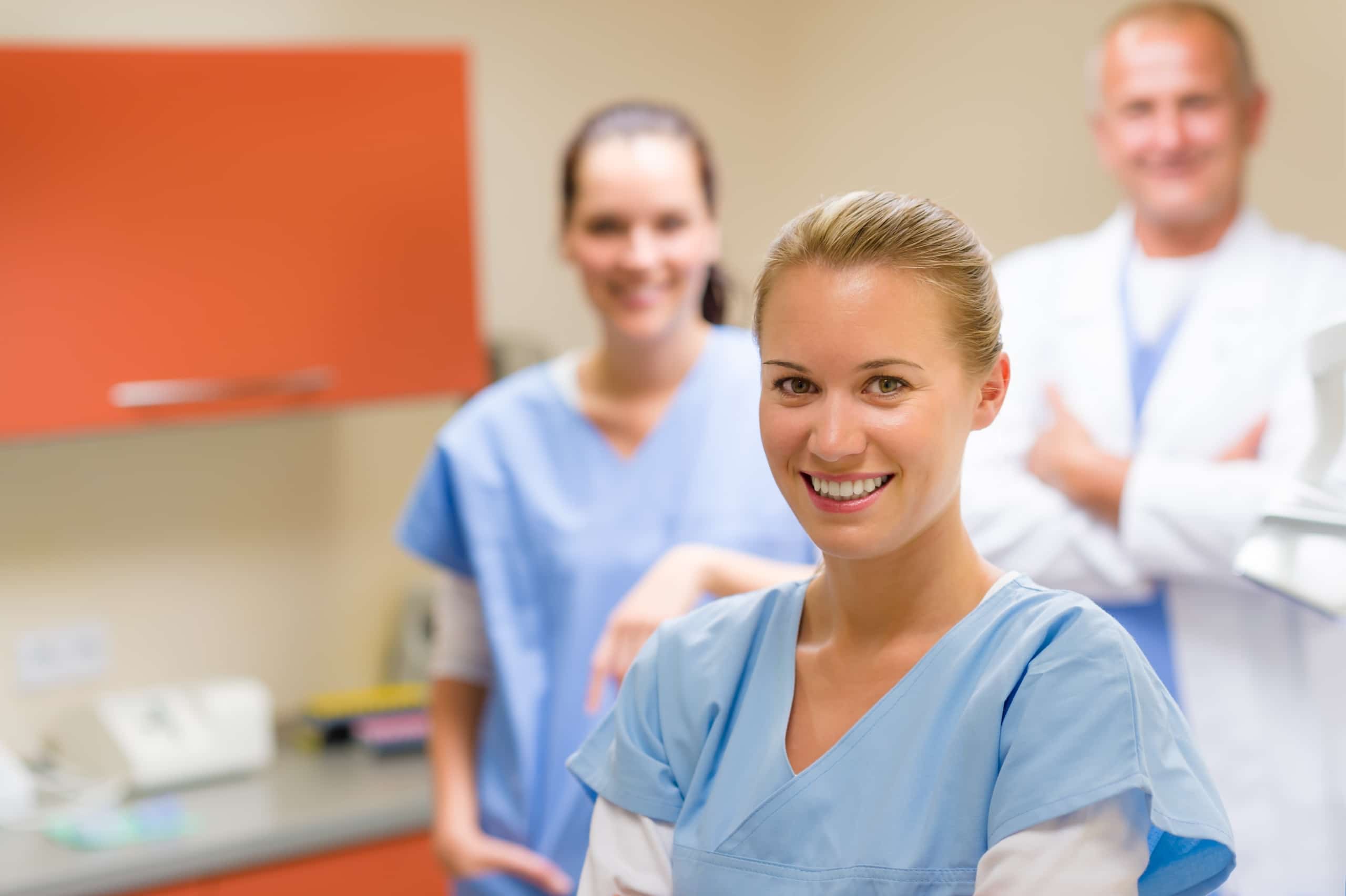 Group of smiling healthcare professionals in an exam room