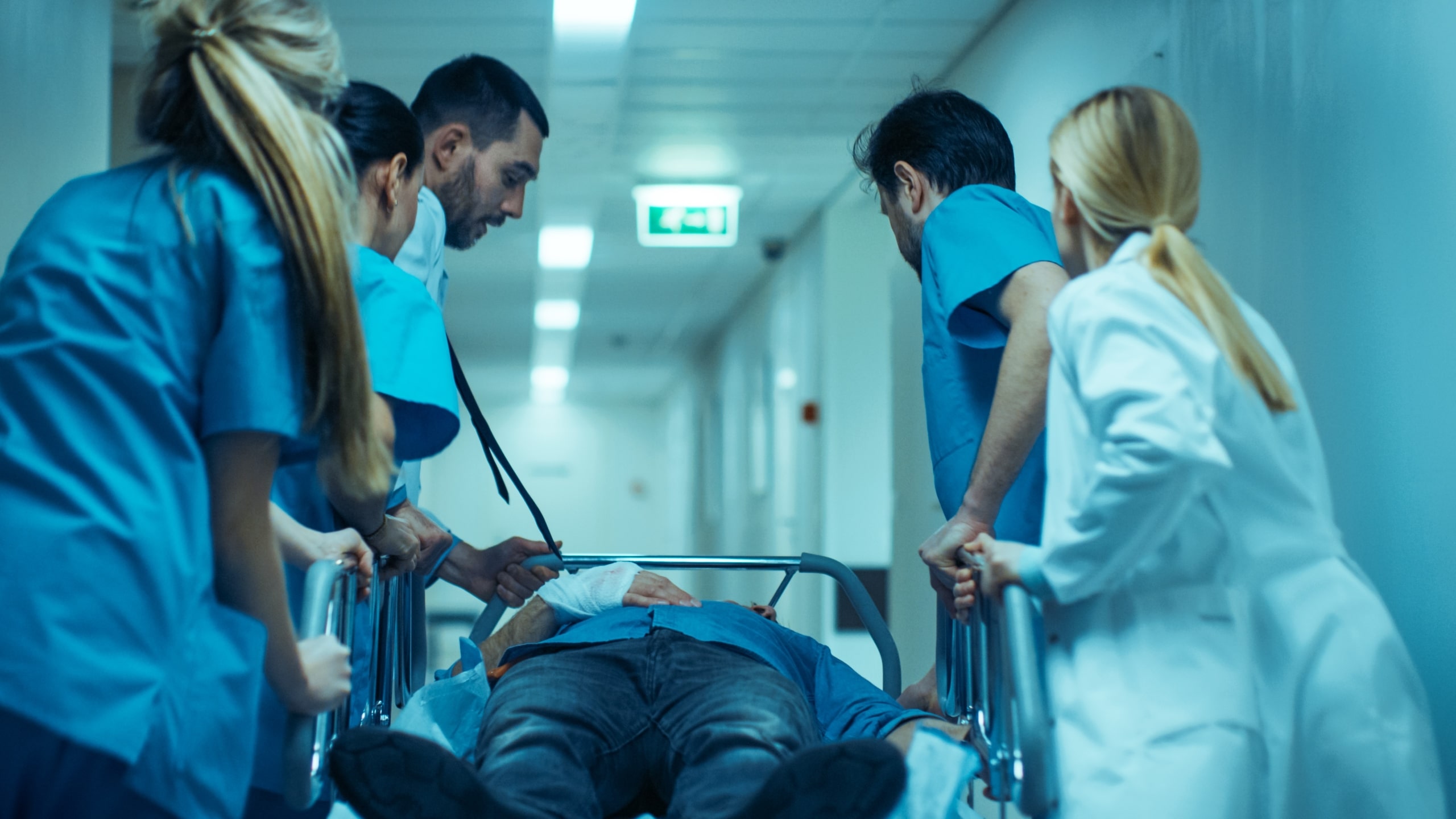 Team of medical professionals transporting a patient