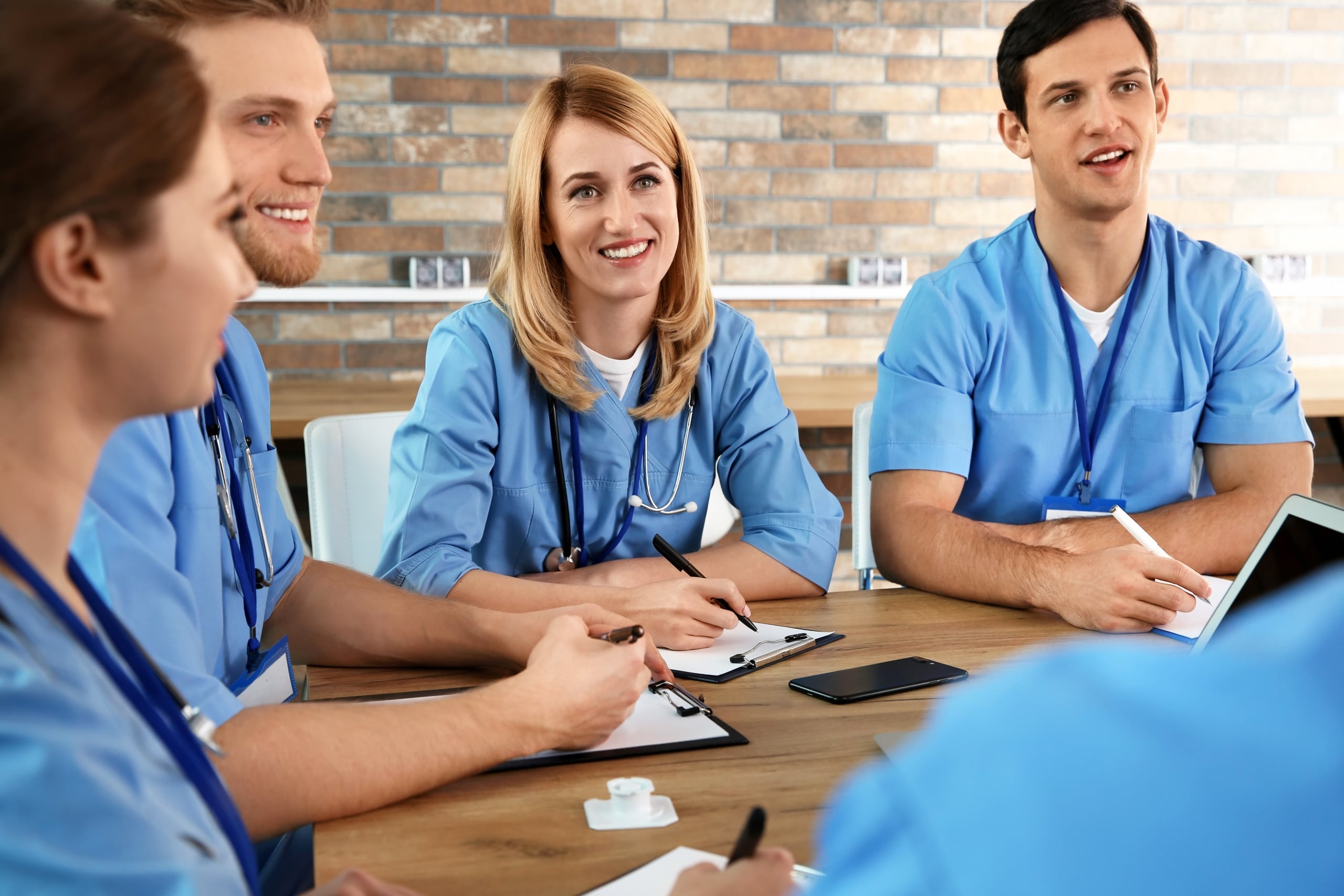 Smiling medical students at a table
