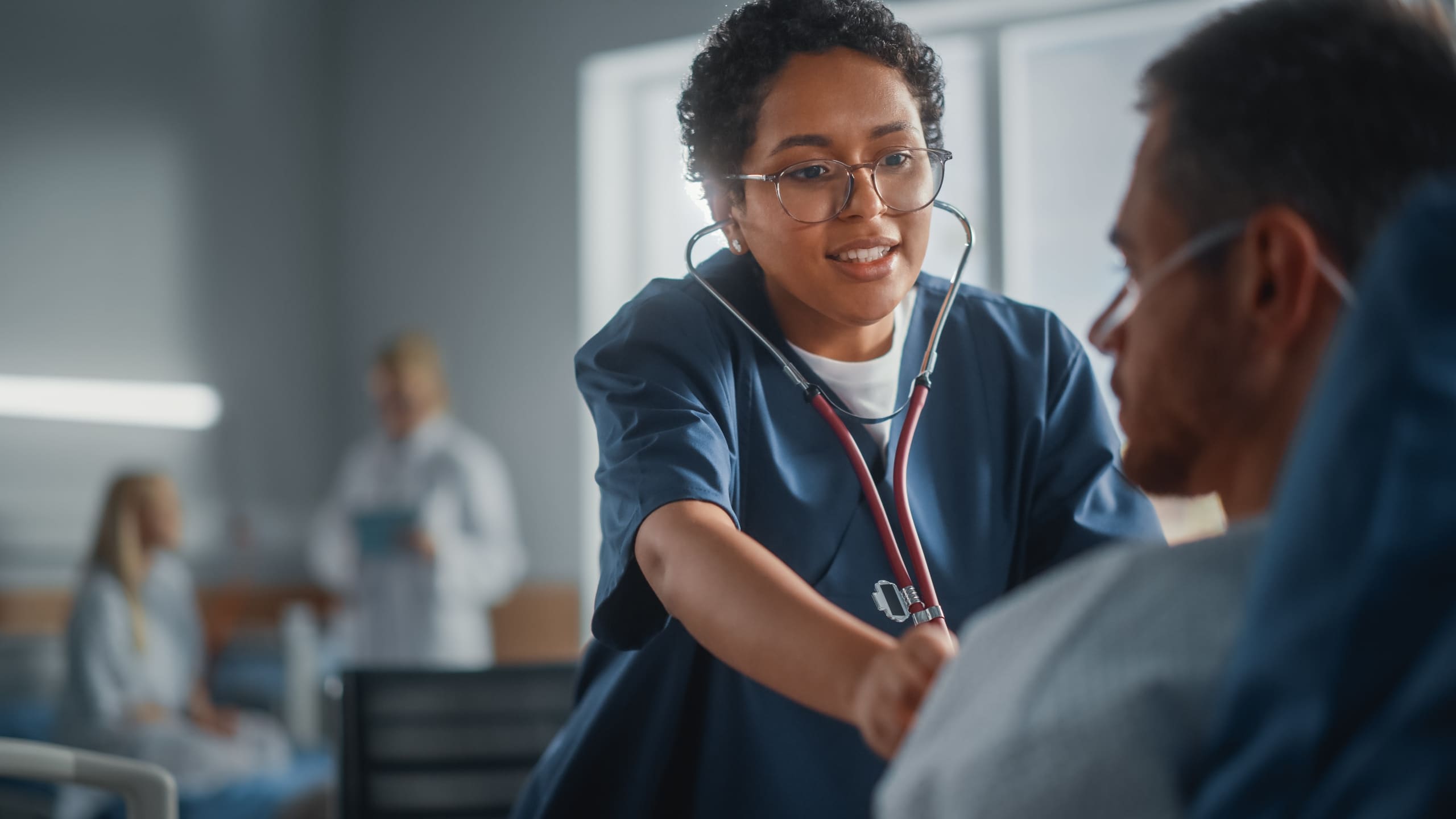 Close up of a nurse using a stethoscope