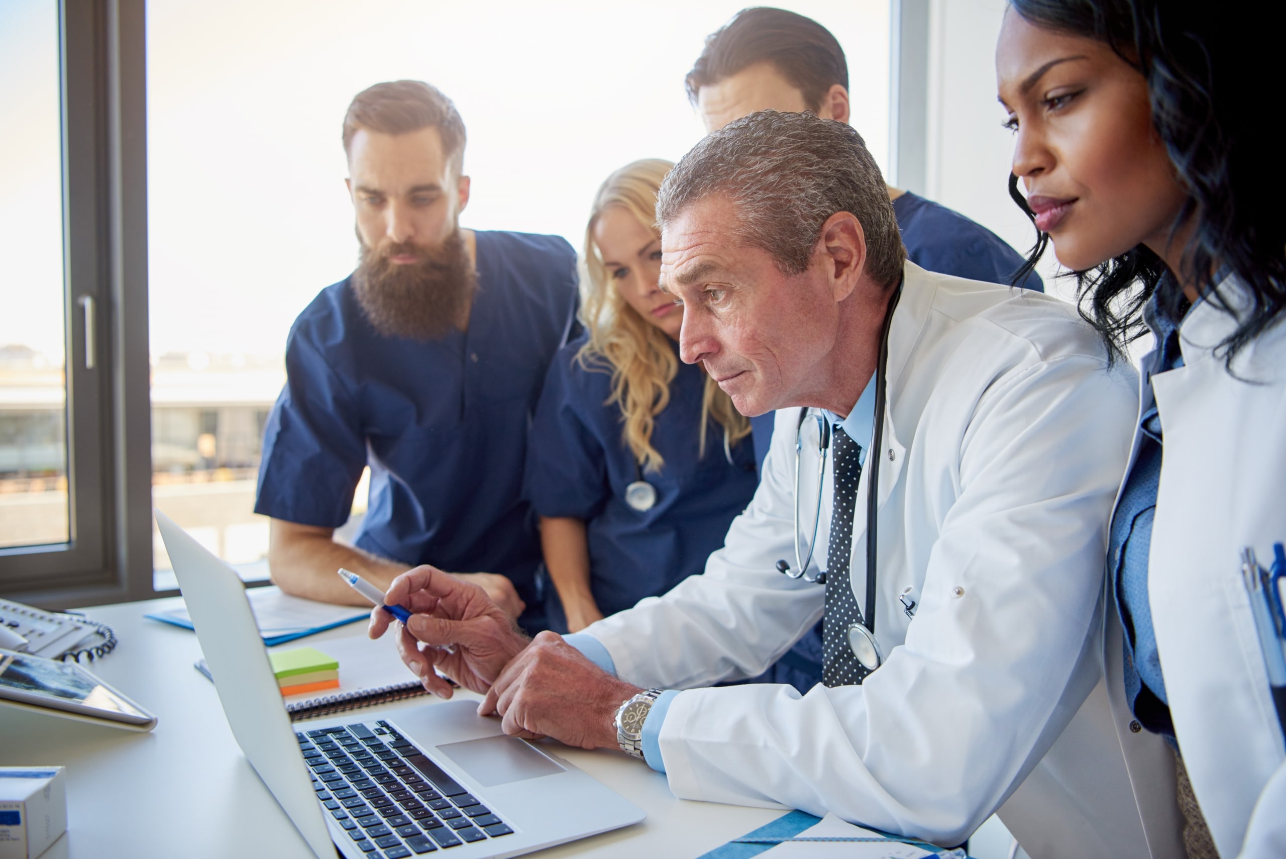 Multiethnic team of medical professionals on a laptop
