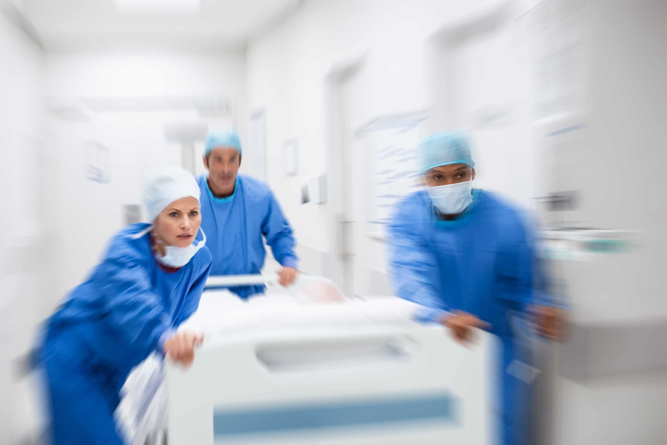 Blurred image of medical professionals in a hallway