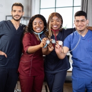 Smiling hospital medical staff holding stethoscopes