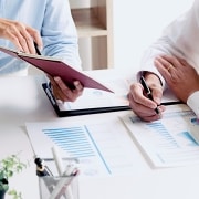 Close up of business professionals reviewing paperwork