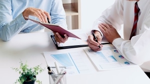 Close up of business professionals reviewing paperwork