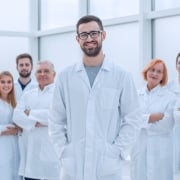 Group of smiling medical professionals in white coats