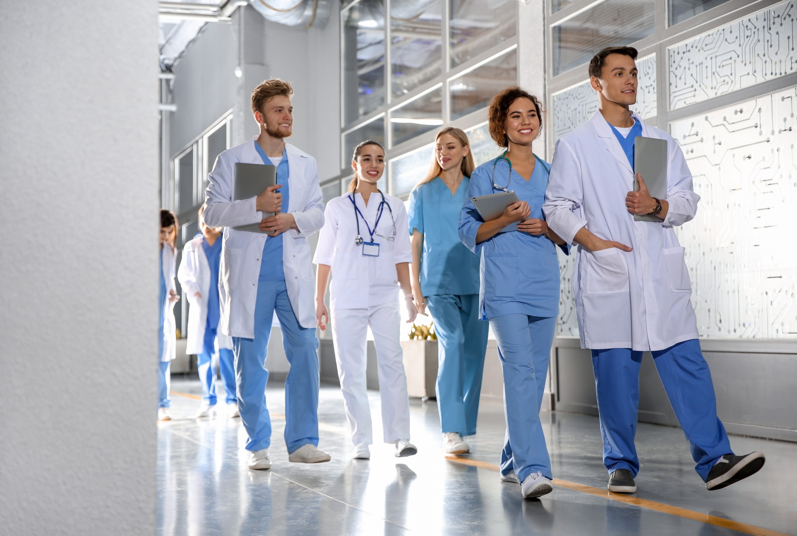 Smiling medical students walking in a hallway