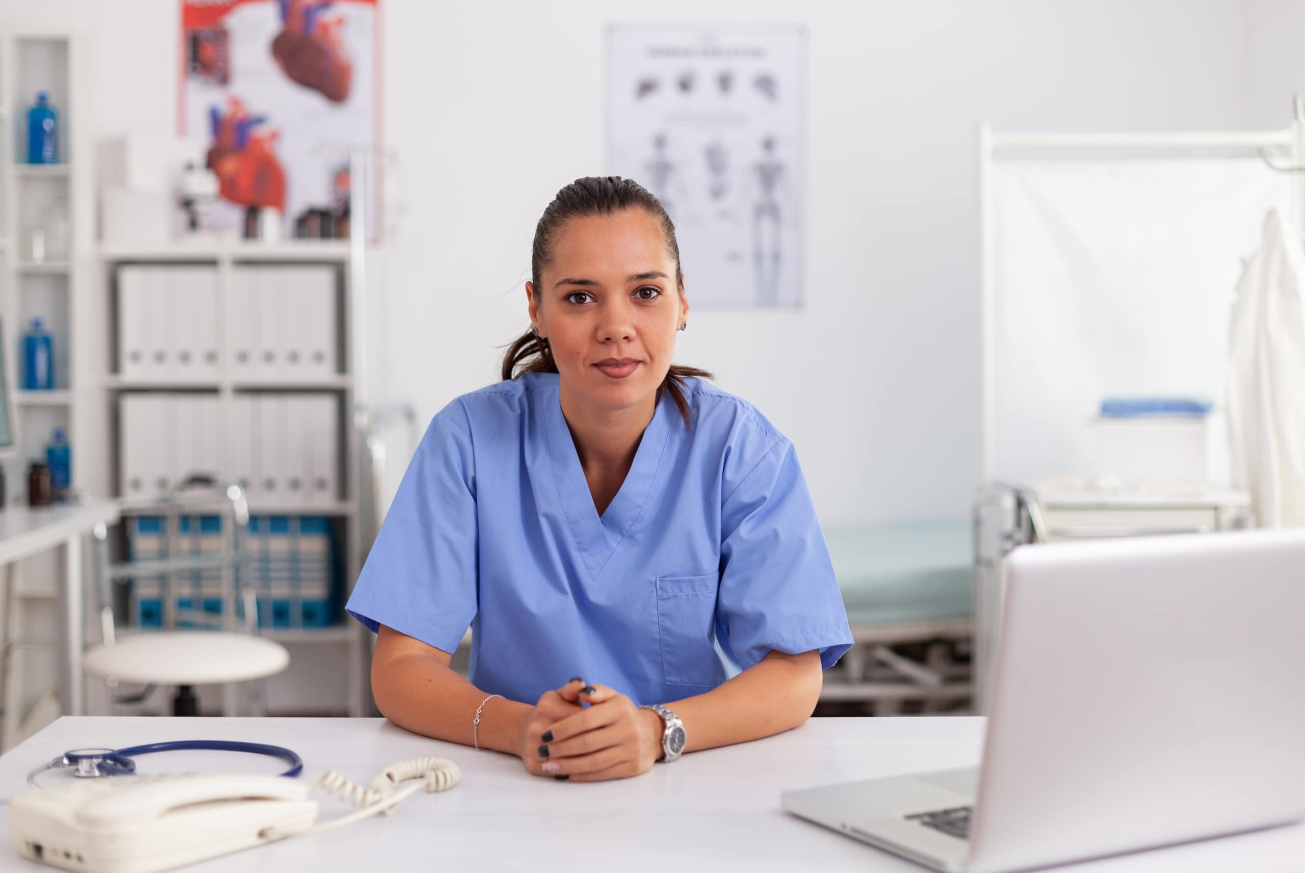 Serious female medical professional at a desk