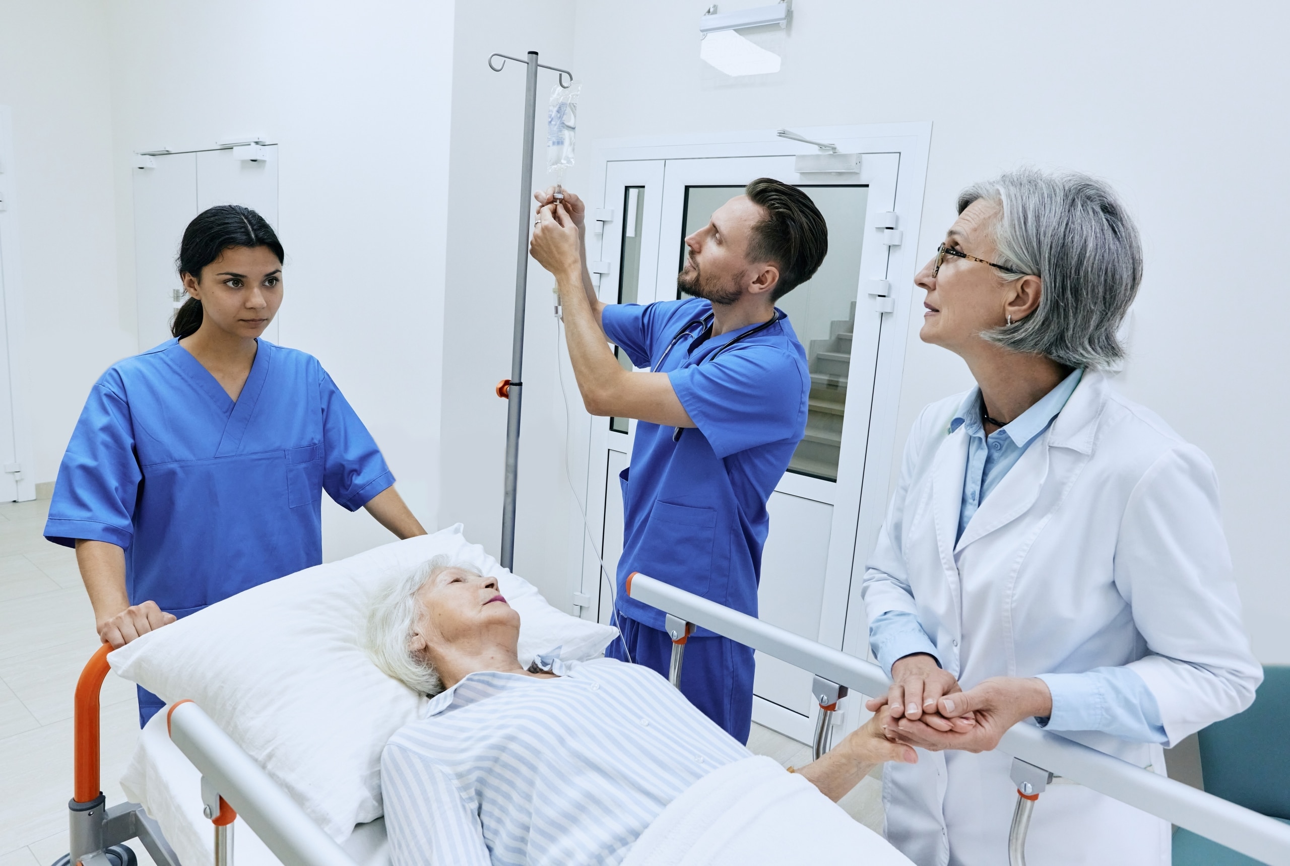 Team of medical professionals with an elderly female patient