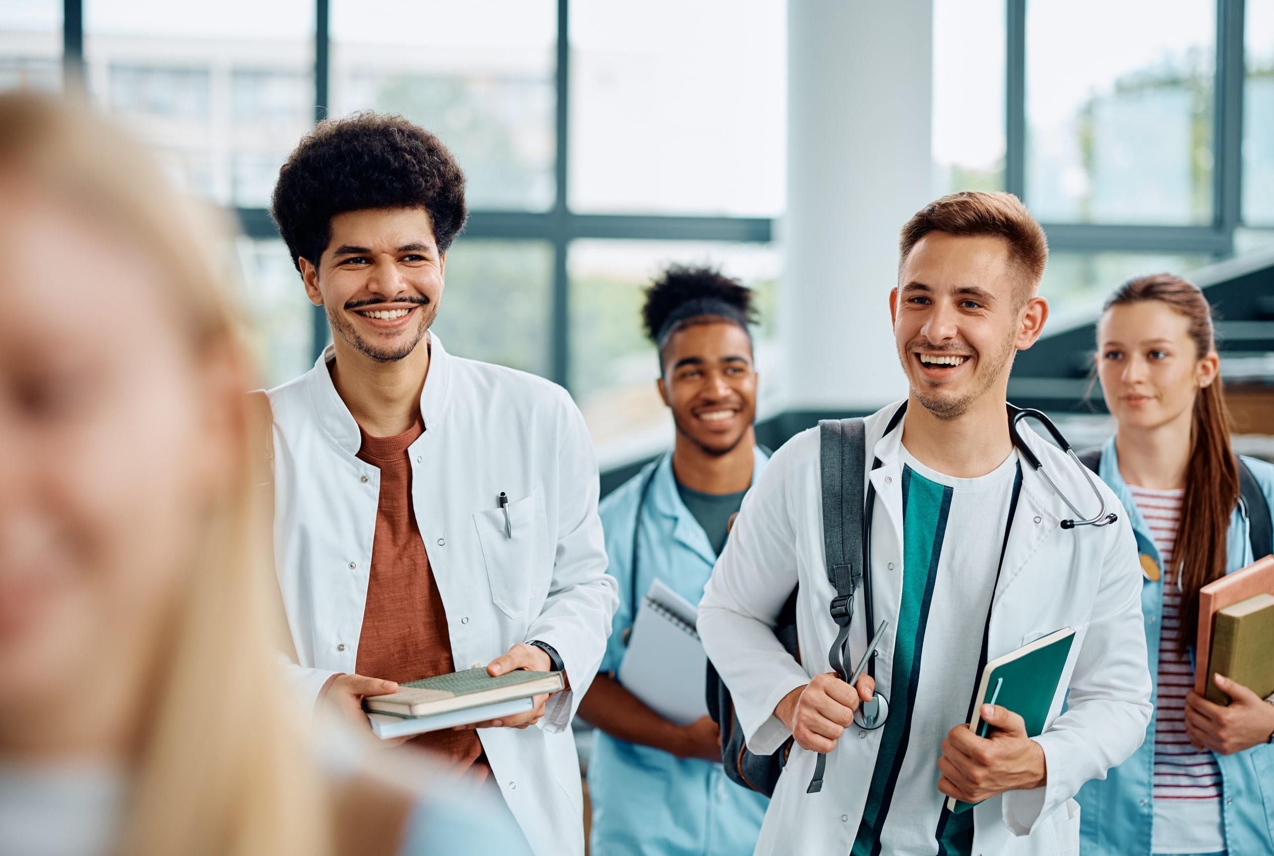 Multi-ethnic group of medical students smiling in a hallway