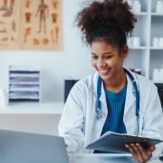 Smiling African-American medical professional at a desk