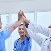 Group of female nurses high fiving each other