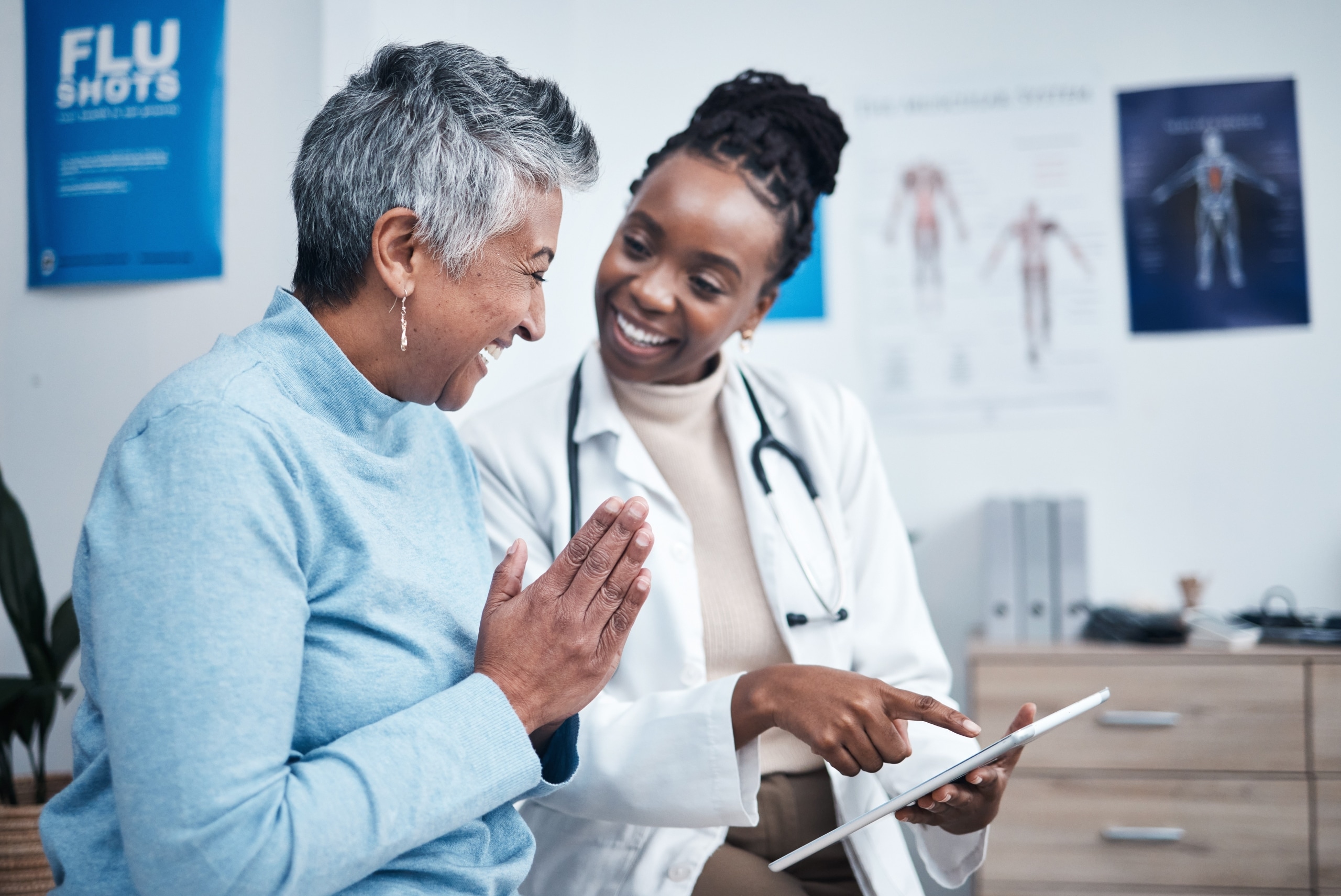 African-American professional speaking with an older female patient