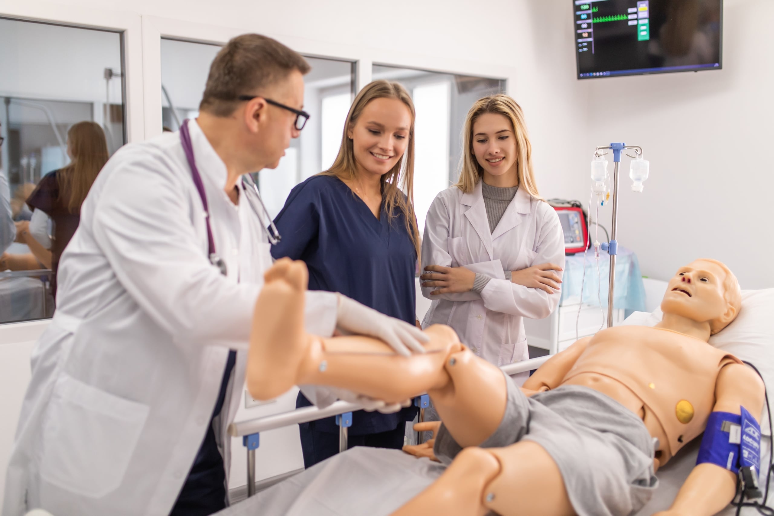 Medical students and an instructor practicing on a mannequin