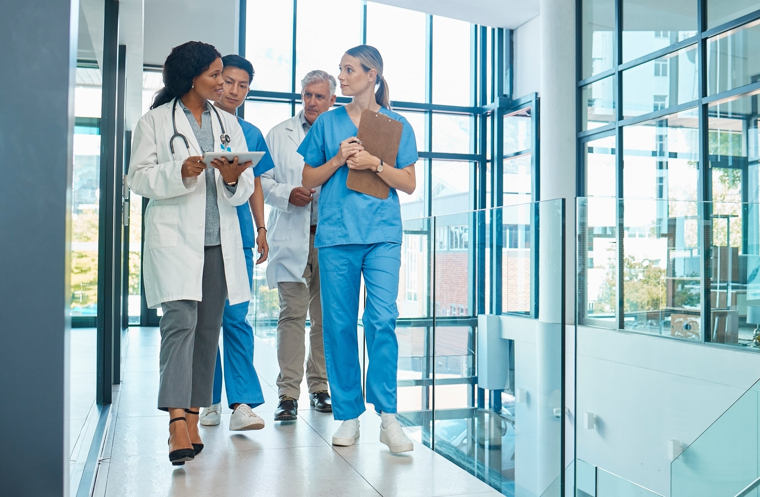 Group of diverse medical professionals walking in a hospital