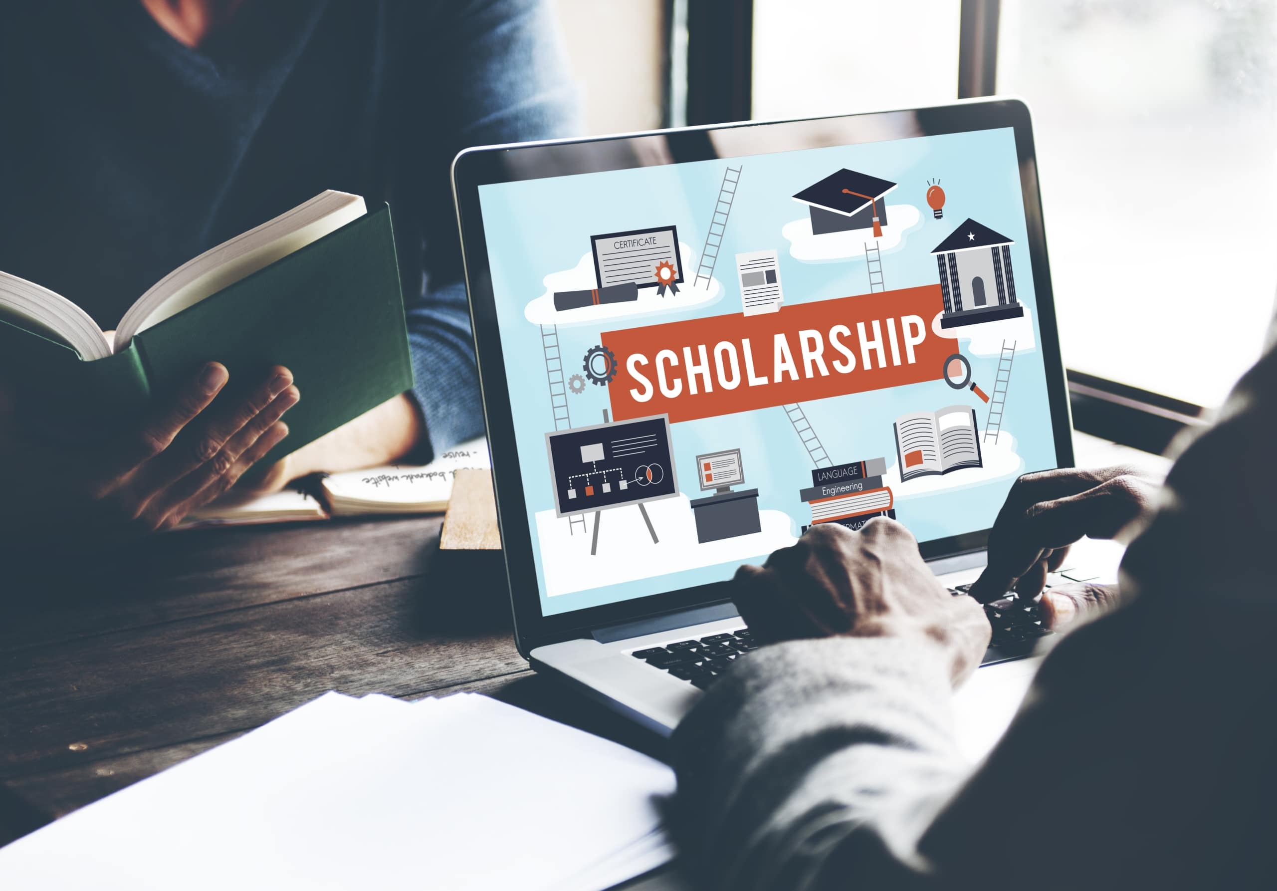 Person looking at scholarship information on a laptop