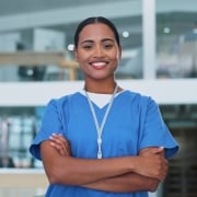 Smiling nurse with her arms crossed in a hospital