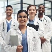 Smiling group of healthcare professionals in a staggered line