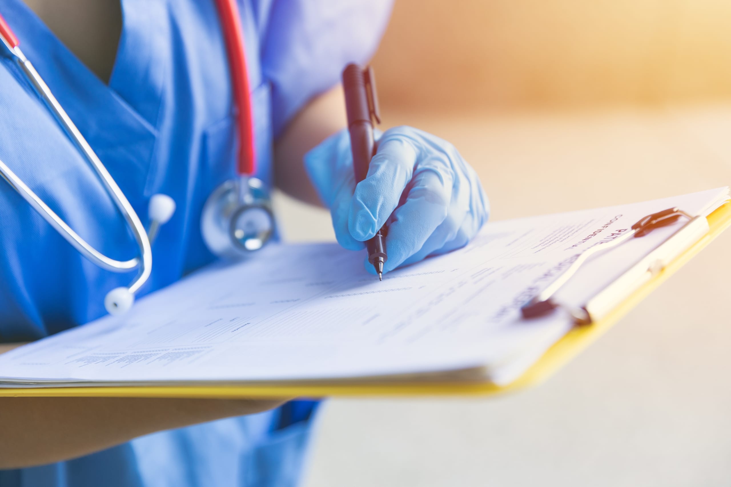 Close up of a nurse completing paperwork