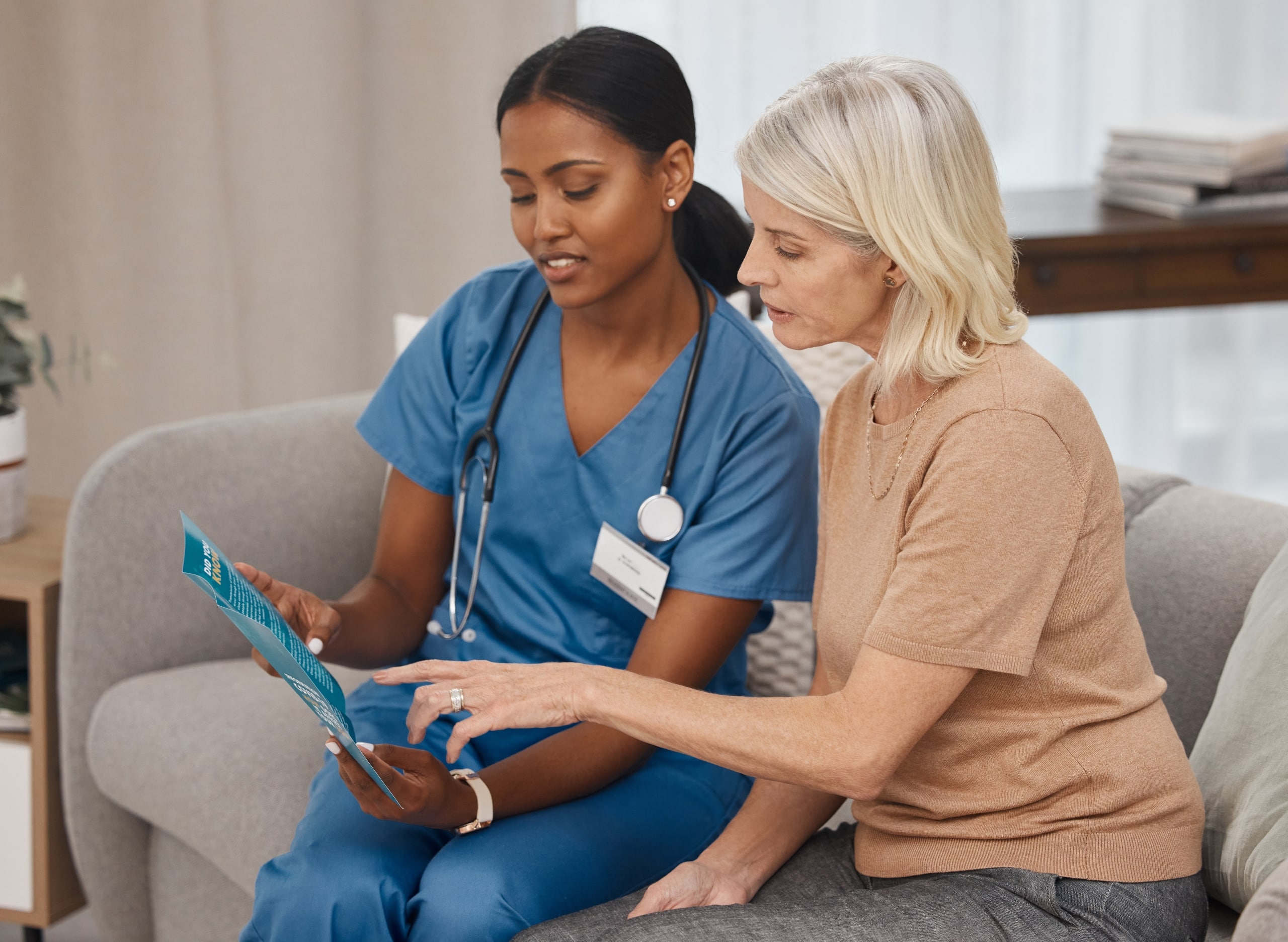 African-American nurse going over paperwork with a female patient