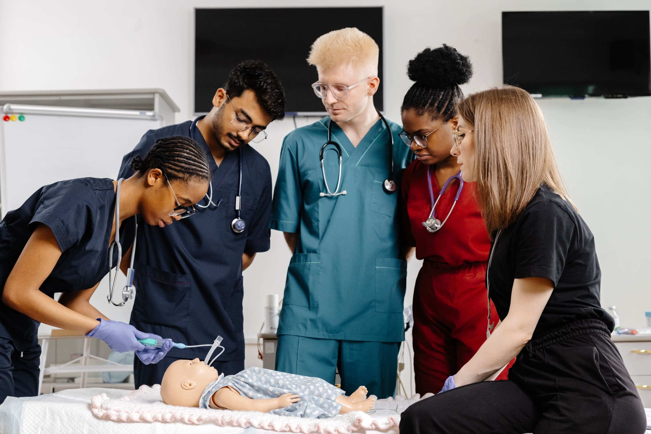 Group of medical students practicing on a mannequin
