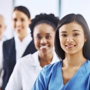 Team of diverse medical professionals standing in a line